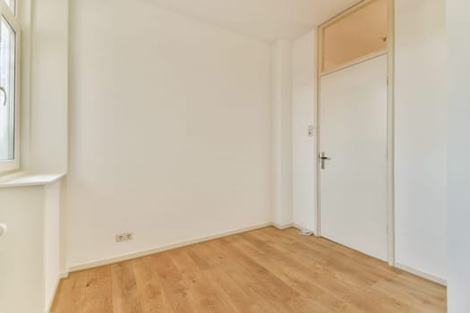 A spacious interior featuring a light color scheme with wooden flooring and a simple doorway. Ideal for minimalist design concepts.
