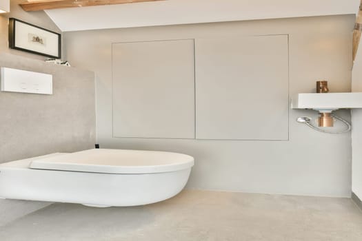 A sleek and contemporary bathroom featuring a white toilet, neutral tones, and minimalist decor. Ideal for modern interior inspiration and design.