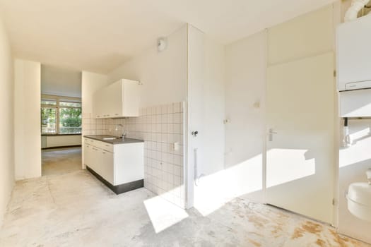 A bright and airy modern kitchen featuring minimalistic design elements, sleek cabinetry, and ample natural light from large windows.