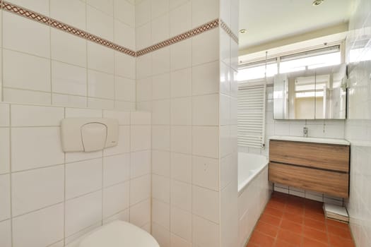 A stylish modern bathroom featuring sleek tiles, a wooden vanity, and contemporary fixtures. The layout promotes functionality and elegance in small spaces.