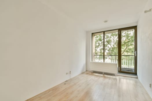 A bright and airy interior space featuring large windows that invite natural light. The minimalist design emphasizes simplicity and tranquility.