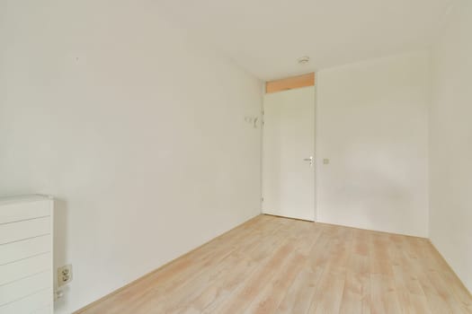 A clean and minimalist empty room featuring light wooden flooring and plain white walls, ideal for various interior design concepts and creative layouts.