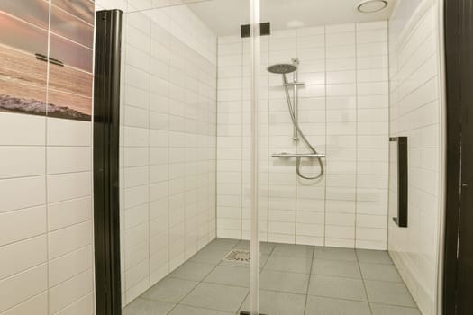 A sleek and modern shower stall featuring tiled walls and a minimalist design, creating a refreshing bathing space that combines functionality and style.