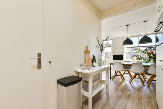 A bright and airy kitchen interior showcasing modern design elements with wood accents and sleek furniture, providing a contemporary and inviting atmosphere.
