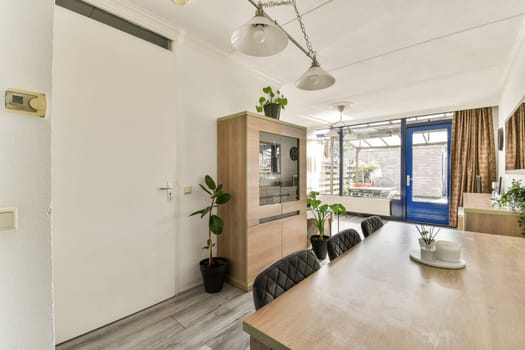 A stylish room showcasing modern furniture, large windows, and plants, emphasizing a bright and airy atmosphere perfect for relaxation and socializing.