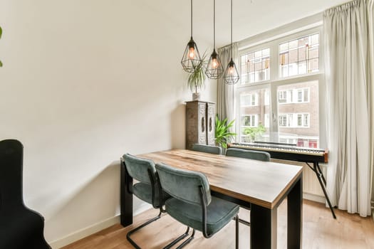 A stylish dining room featuring modern decor, natural light streaming through large windows, and contemporary furniture for a cozy ambiance.