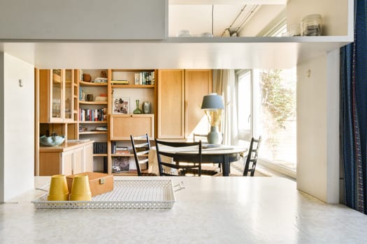 A stylish kitchen featuring warm wood cabinetry and a bright open space that seamlessly connects with the dining area, offering a cozy ambiance for meals and gatherings.