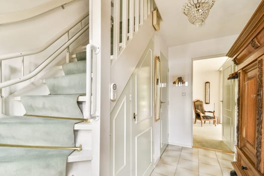 A bright and inviting modern interior showcasing a plush staircase, elegant decor, and light-filled rooms that create a cozy atmosphere.