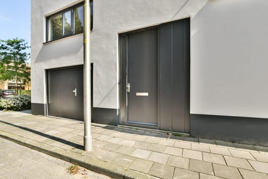 A sleek and minimalist urban building facade showcasing gray walls, modern doors, and clean lines, suitable for contemporary architectural designs.