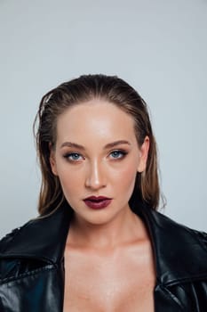 Fashionable woman in black clothes and makeup on white background