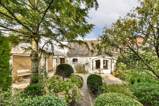 A picturesque garden featuring a variety of plants and trees, creating a tranquil and inviting atmosphere, perfect for relaxation and nature appreciation.
