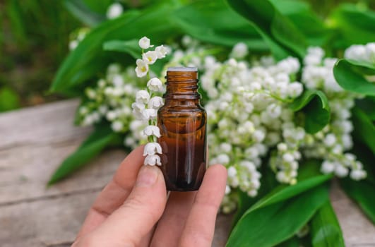Lily of the valley extract in a bottle. Selective focus. nature.