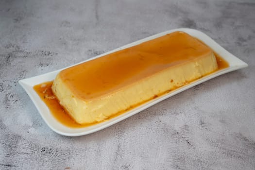 Cream caramel pudding with caramel sauce on a plate, Flan, High quality photo