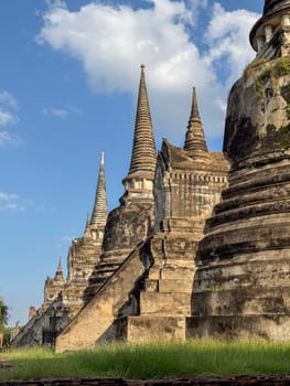 Wat Chaiwatthanaram Ayutthaya temple seen from river boat, ancient famous brick towers under a golden sunset. Traditional heritage, culture. Amazing majestic religious structure.