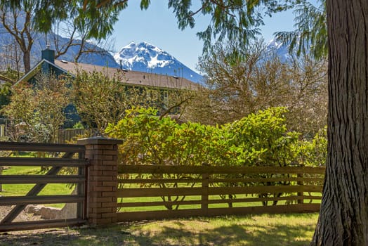 Gated residential area of a small town in Canada with snow top mountain view.