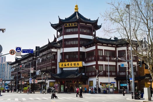 Shanghai, China – 1 April 2025: Traditional architecture and tourists on Yuyuan Old Street, a historic shopping area near Yu Garden in Shanghai Old City