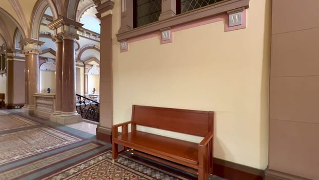 The design showcases stunning architecture with a beautifully crafted wooden bench in a charming historic building