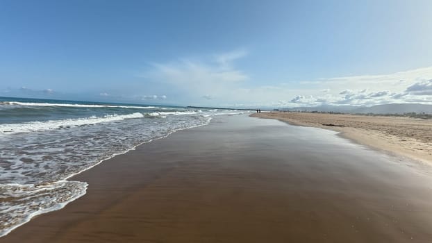 Imagine a tranquil beach scene showcasing soft golden sand along with gentle ocean waves beneath a bright sky