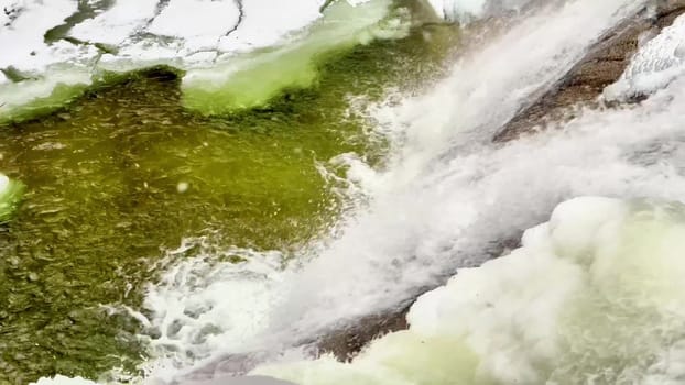 Mountain frozen waterfall in snowfall. High quality 4k footage