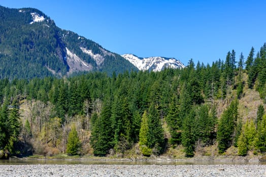 View at snowy mountains in British Columbia. Stoney mountain riverbed.