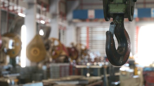 Closeup of swivel chain hook crane of electric hoist in factory workshop, pullersSwivel chain hook equipment for pullers, industry lifting machine