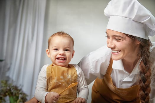 A family enjoys a fun cooking session, playfully covered in flour while engaging with their little ones in warm kitchen. Mother and son having fun