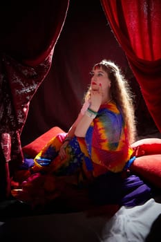 Blonde woman showcases traditional Indian attire, contemplating thoughtfully in a richly decorated setting, embracing cultural style.