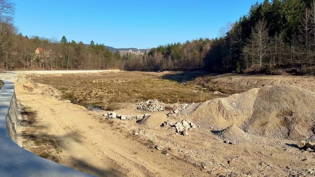 Aerial views of a dramatically changed landscape with gravel piles and earthworks in a natural setting