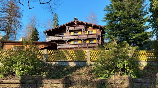 A charming wooden house peacefully nestled among lush, vibrant trees, perfect for relaxation and serene retreats