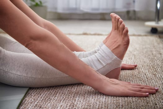 Individual stretches in a cozy indoor space, engaging in yoga to enhance flexibility and promote a healthy lifestyle during the day.