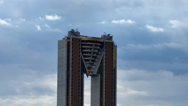 Behold a breathtaking view of an innovative skyscraper that beautifully showcases modern architectural design and style