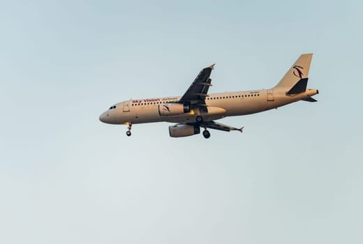 Cairo, Egypt - 7 November 2024: Sky Vision Airbus A320-232 jet plane with landing gear descending to land