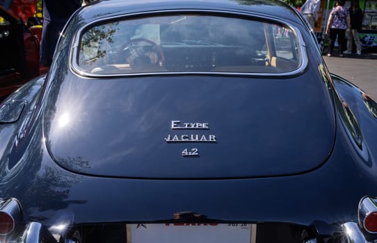 Georgetown, TX - 3 May 2025: Rear view of a restored dark blue E-Type Jaguar 4.2 at a Texas car show