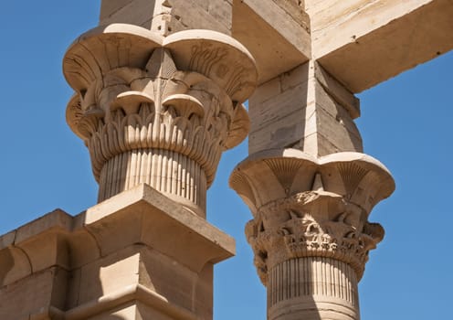 Detail of the bas-relief carving of the tops of the columns in the Philae Temple in Aswan Harbor or Reservoir in Egypt