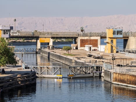 Approaching the new Esna dam and lock on Nile River with gates open for entry