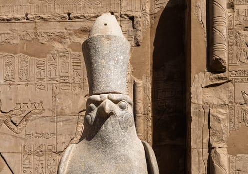 Detail of the carved statue of Horus outside the Pylon at the entrance of the massive temple in Edfu dedicated to Horus and Hathor