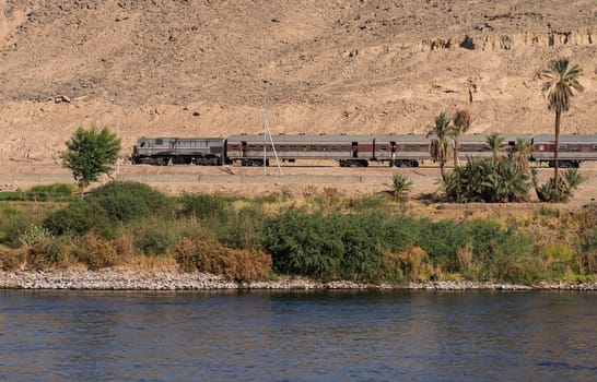 Egyptian passenger train alongside the River Nile near Aswan and heading north