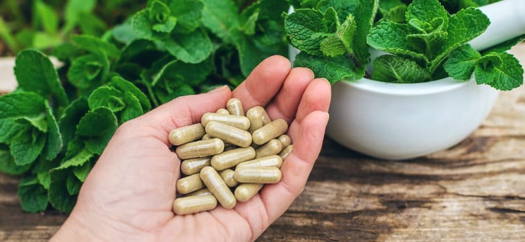 Peppermint extract essential oil and supplements. Selective focus. nature.