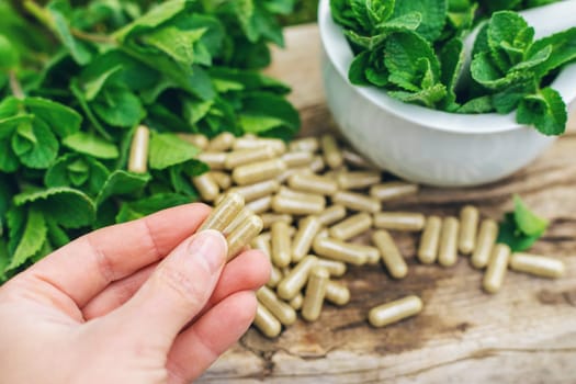 Peppermint extract essential oil and supplements. Selective focus. nature.