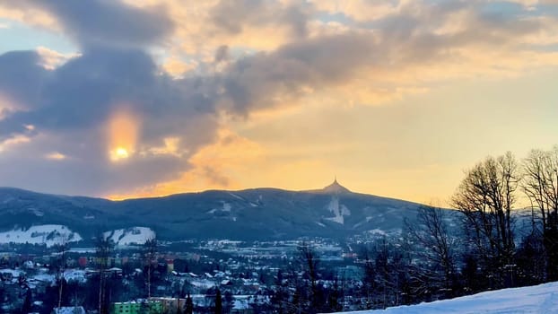 Beautiful sunset over snow-capped mountains and city Liberec. High quality 4k footage