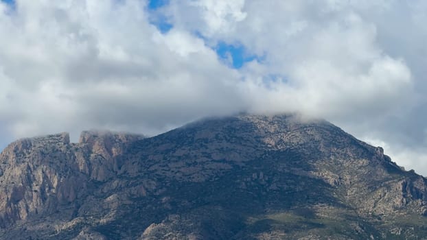 A breathtaking mountain landscape beautifully showcasing its grandeur beneath a dynamic and everchanging sky
