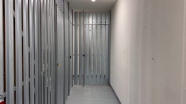 A clean and spacious hallway showcasing metal framing, which is indicative of ongoing construction work activities