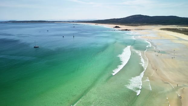 Breathtaking aerial view showcasing a stunning pristine beach featuring turquoise waters and soft gentle waves