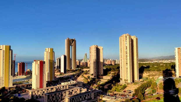 A breathtaking skyline featuring tall buildings and vibrant architecture set against a clear blue sky.