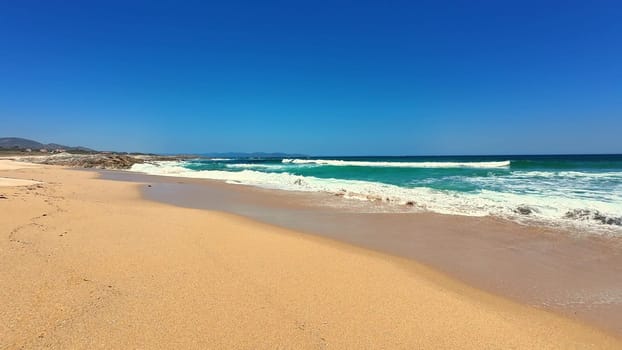 A beautifully picturesque beach scene featuring soft sandy shores, vibrant azure ocean water, and bright sunny skies