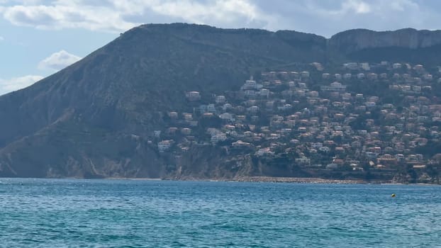 A stunningly beautiful coastal view showcases a delightful hillside community alongside serene blue waters