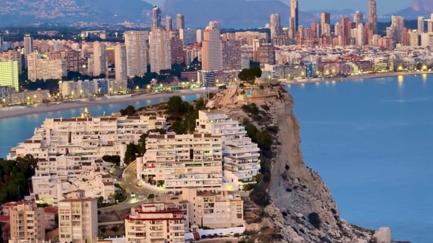 An aerial view highlights a vibrant coastal cityscape, showcasing modern architecture and natural beauty