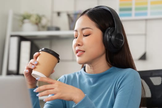 In a cozy office environment, a woman reflects on her design work while sipping coffee, capturing the duality of creativity and thoughtful consideration.