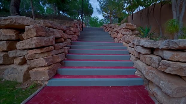 Enjoy a lovely walk on a beautiful stone path with steps surrounded by lush greenery and serene views