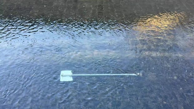 A calm and serene view of a paddle gently resting atop the still water, beautifully reflecting natures tranquility